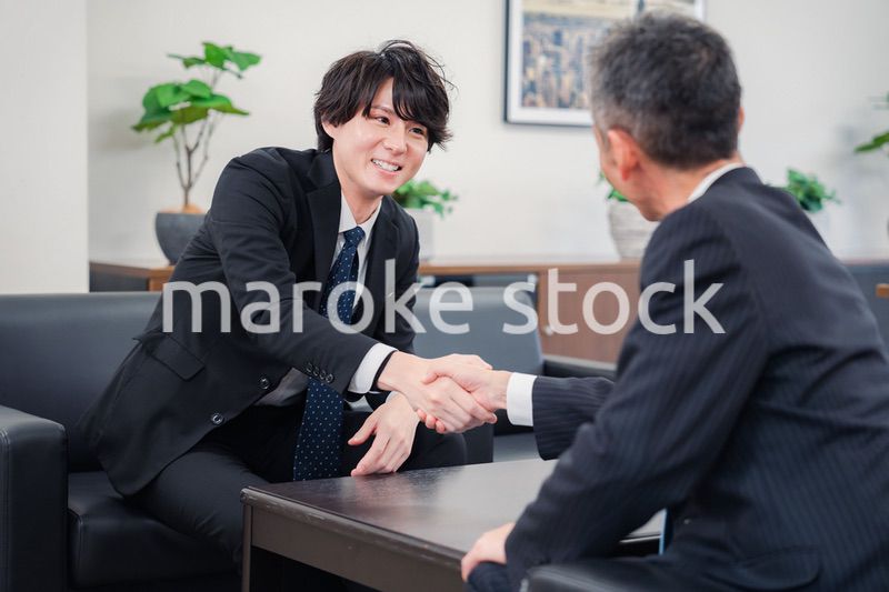 B2B商談で握手を交わすビジネスマン