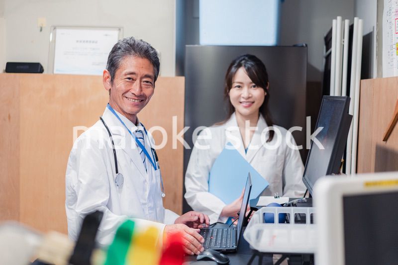 ナースステーションで打ち合わせをする医療従事者たち