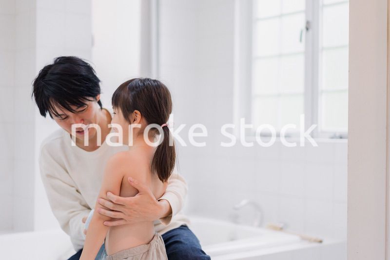 お風呂で娘の体を拭くお父さん