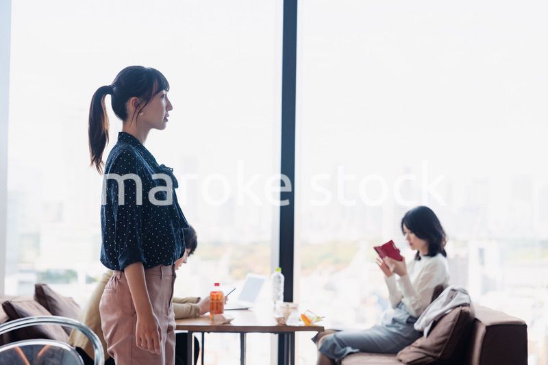 モダンな雰囲気のオフィスのカフェテリアを歩くキャリアウーマン