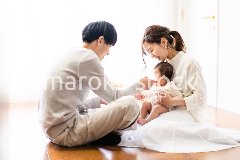 赤ちゃんに絵本の読み聞かせをするファミリー