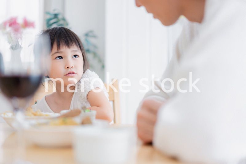 パパと一緒にご飯を食べる小さな女の子