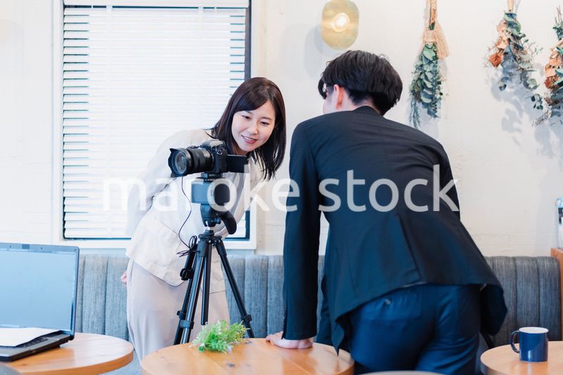 撮影の立ち会いをするビジネスパーソン