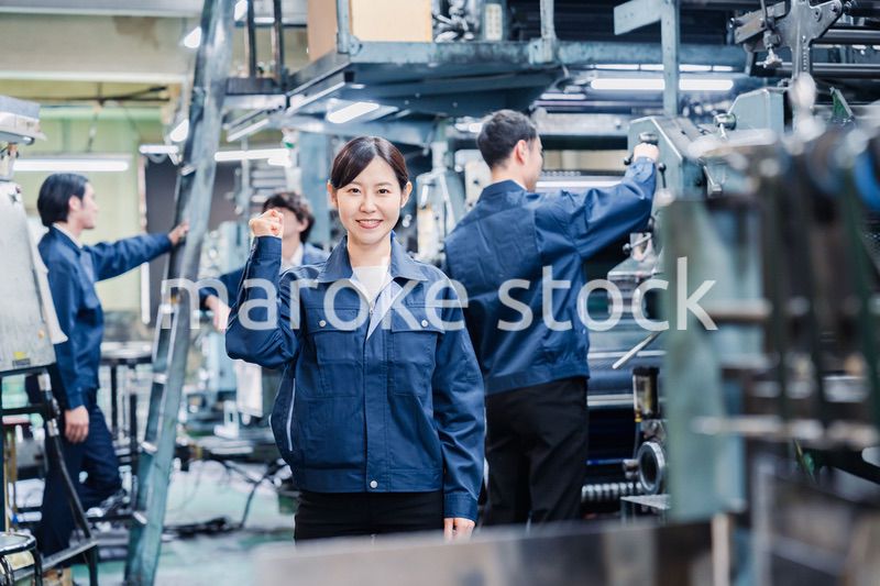 ガッツポーズをする工場労働者