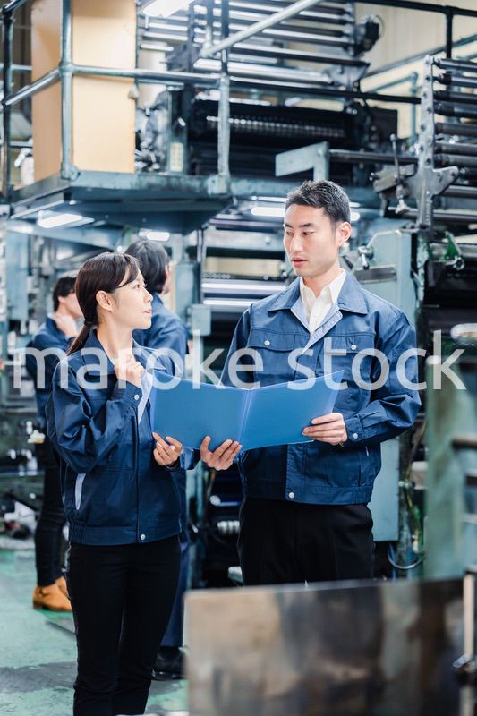 工場で生産計画を確認する労働者