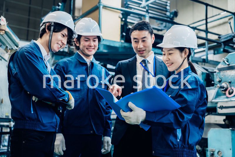 工場で資料を確認する労働者