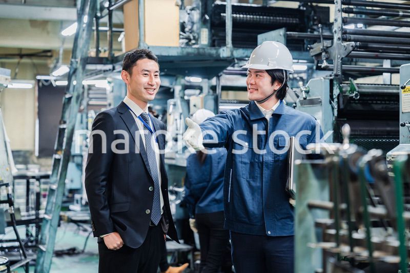 工場を視察するビジネスマン