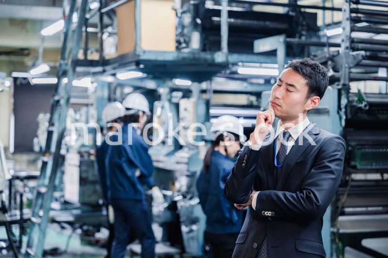 工場で悩むビジネスマン