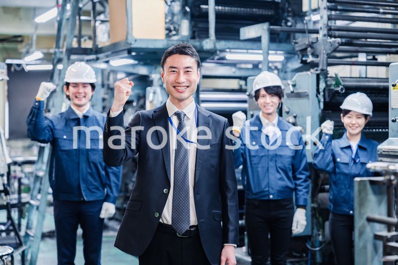 工場でガッツポーズをするスタッフたち