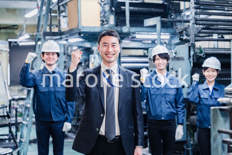 工場でガッツポーズをするスタッフたち