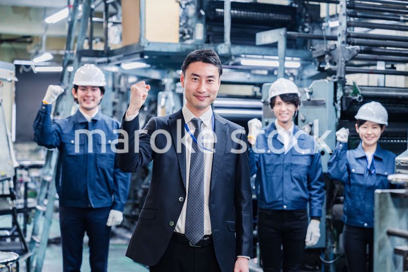 工場でガッツポーズをするスタッフたち