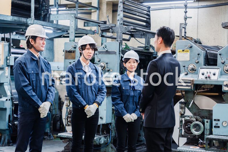 管理職の訓示を聴く工場スタッフ