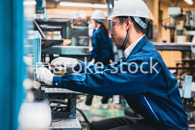 自動車修理工場で働く男性