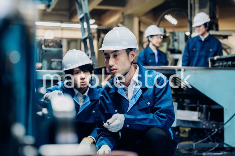 工場で機械の整備をする労働者