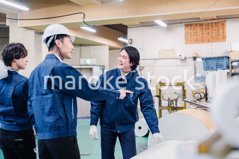 印刷工場でロール紙の確認をする作業員