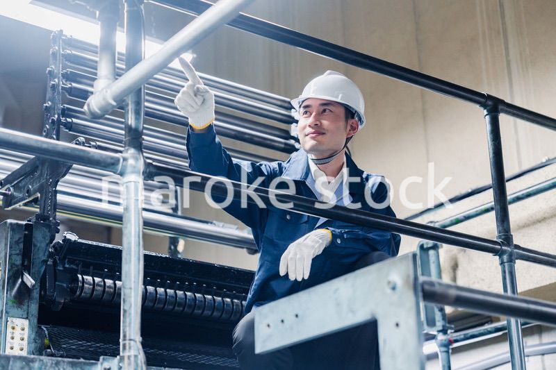 足場で高所作業をする男性作業員