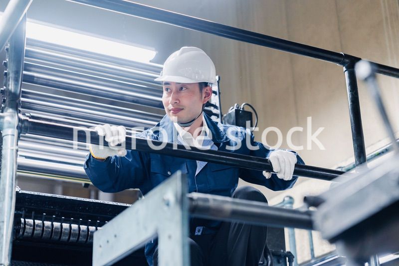 足場で高所作業をする男性作業員