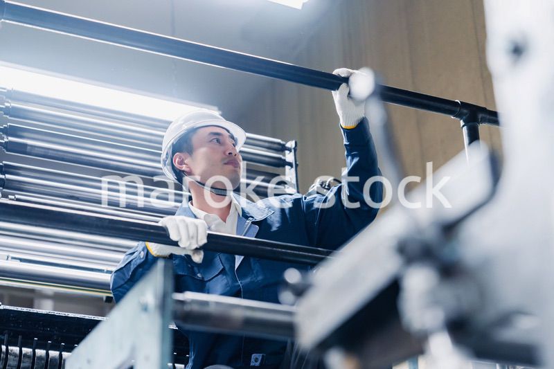 足場で高所作業をする男性作業員