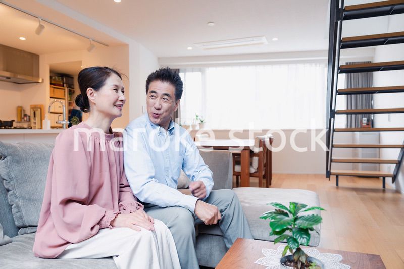 家でテレビを見るシニアの夫婦