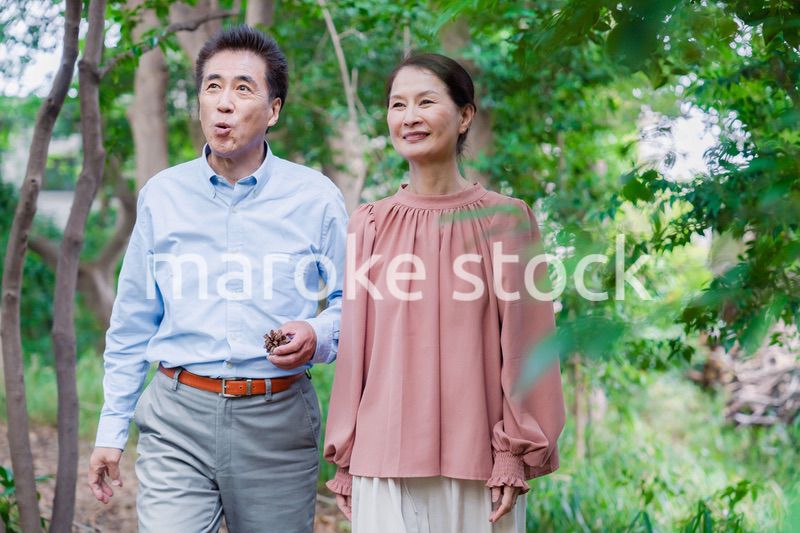 自然の中を散歩するシニアの夫婦