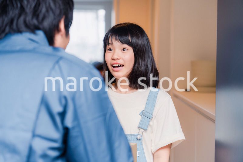 家で宅配便を受け取る小学生の女の子