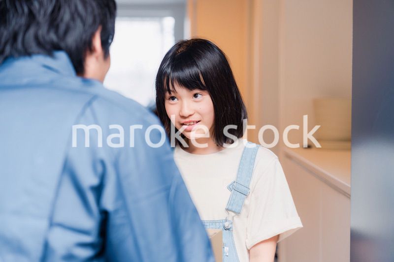 家で宅配便を受け取る小学生の女の子