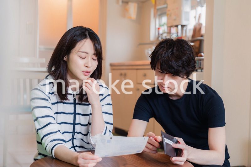 請求書明細を見て値上げに苦しむ若い夫婦