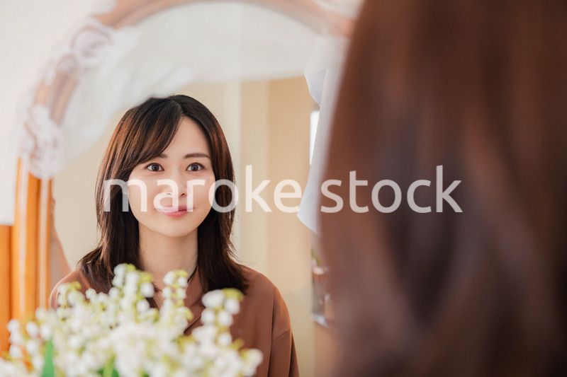 鏡台で身支度をする若い女性