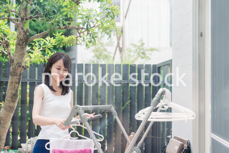 洗濯物を干す若い女性