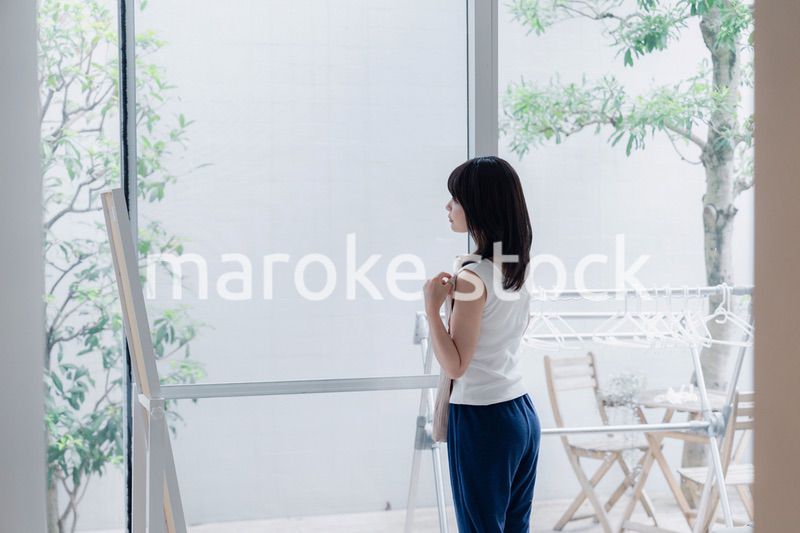 家でファッションの組み合わせを考える若い女性