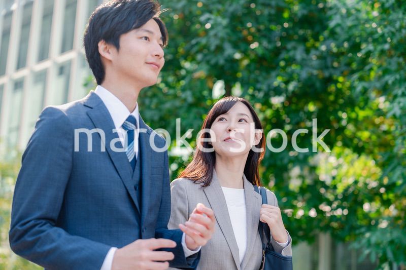 男女で外を歩くビジネスパーソン