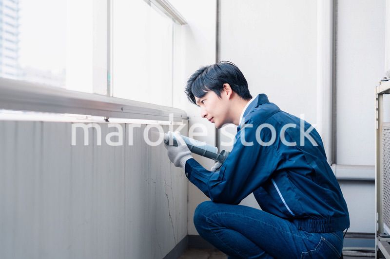 外壁の補修をする男性作業員