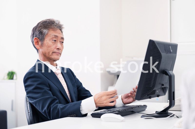 書類を読む中年のビジネスマン