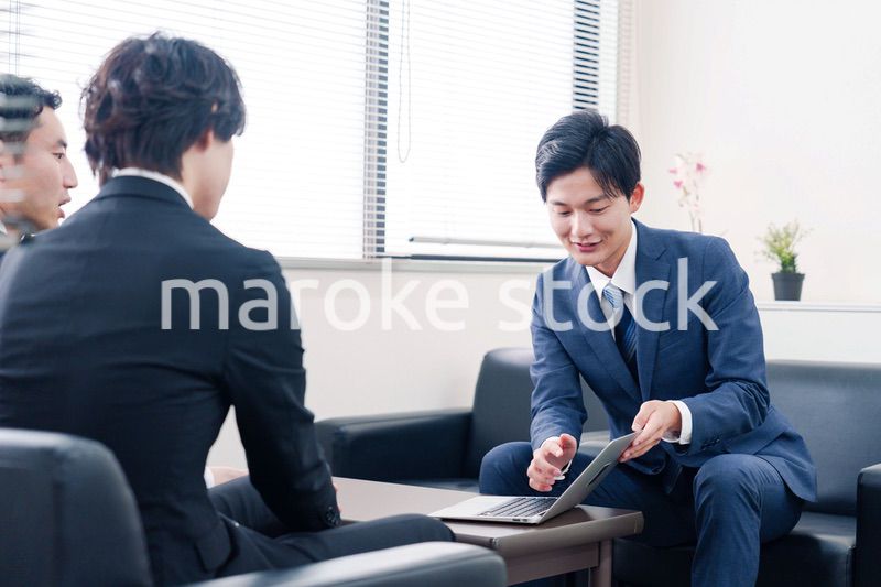 得意先と商談をするスーツを着たビジネスマン