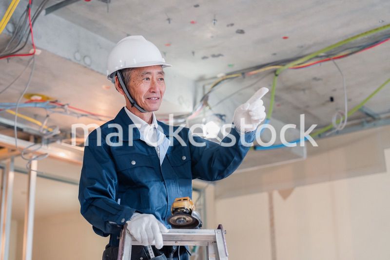 工事中の現場で指差し確認をする職人