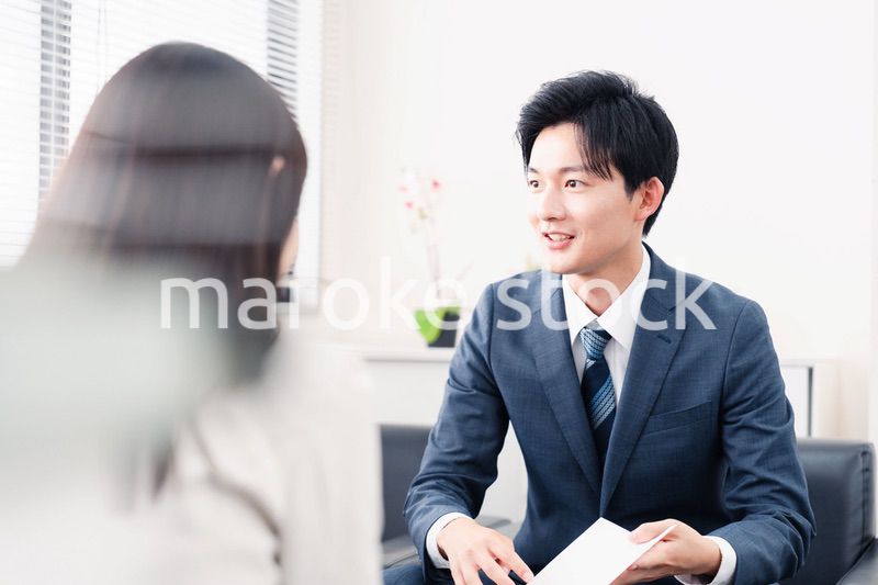 書類を提示する営業マン