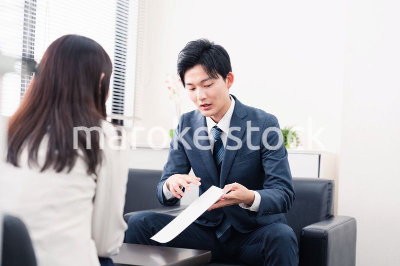 書類を提示する営業マン