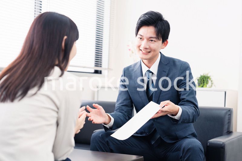 書類を提示する営業マン