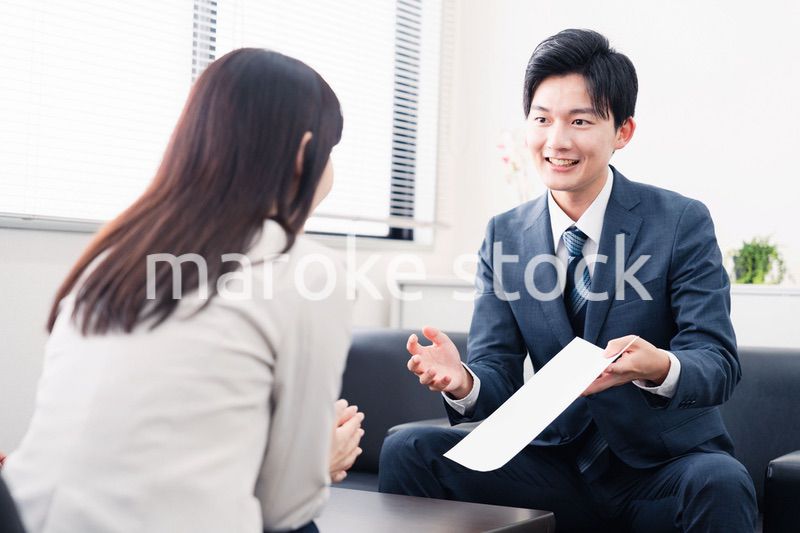 書類を提示する営業マン