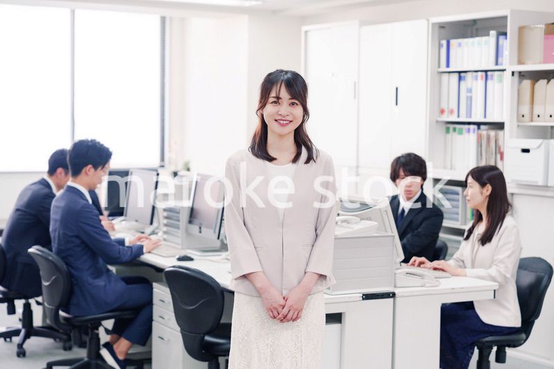 オフィスで笑顔を見せる若い女性社員