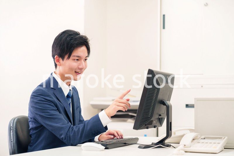 オフィスでデスクワークをする若い男性