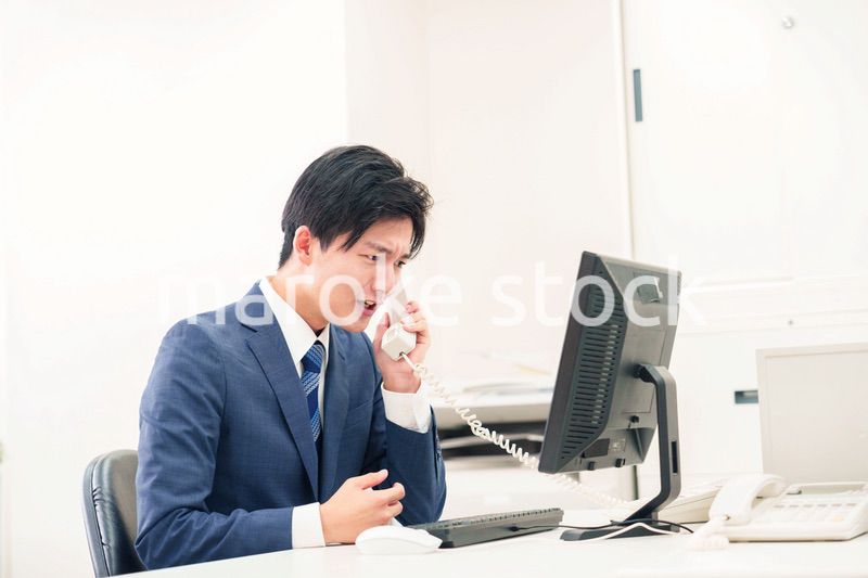 電話で怒鳴るビジネスマンの男性