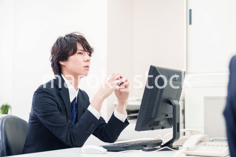 仕事中にルービックキューブをするビジネスマン