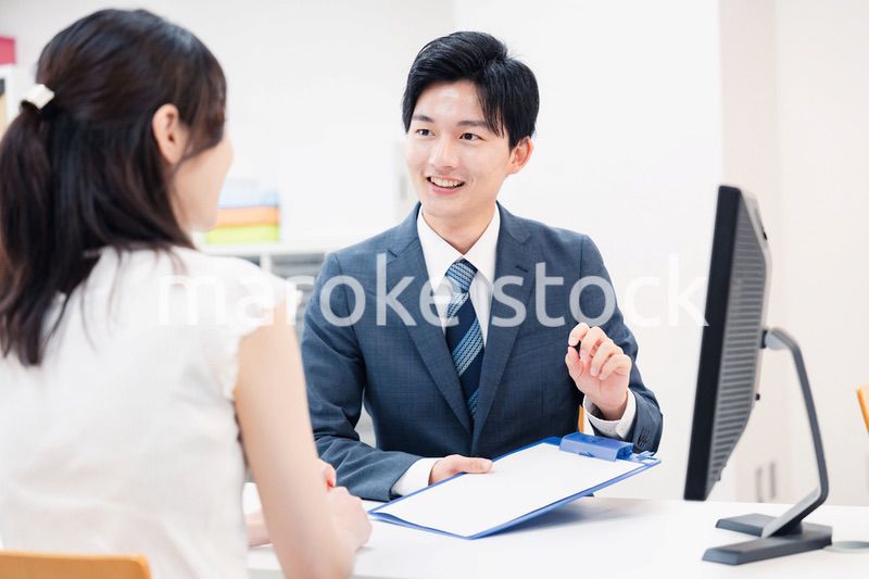 窓口で顧客の要望を聞く男性スタッフ