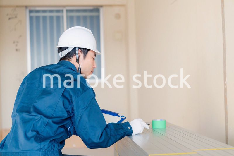 建設現場で資材の確認をする大工