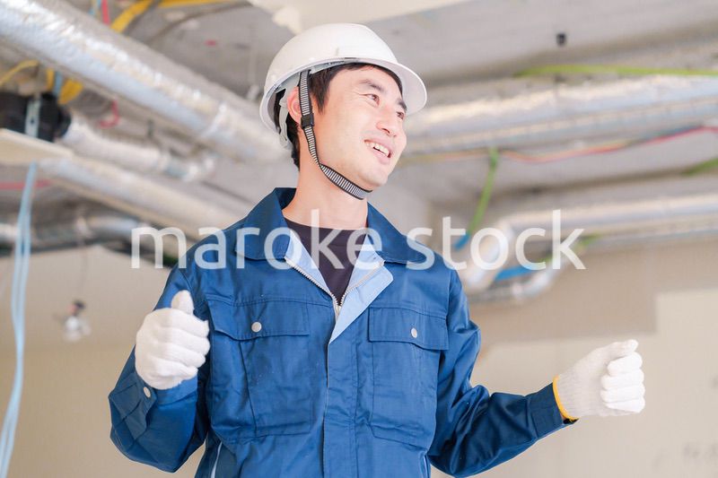 工事現場で楽しく働く職人の男性