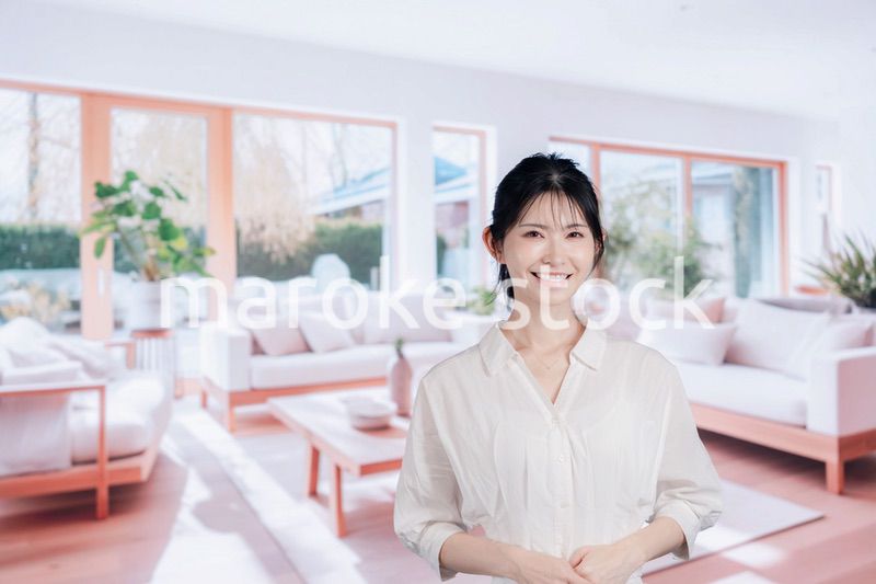 明るいリビングで過ごす若い女性
