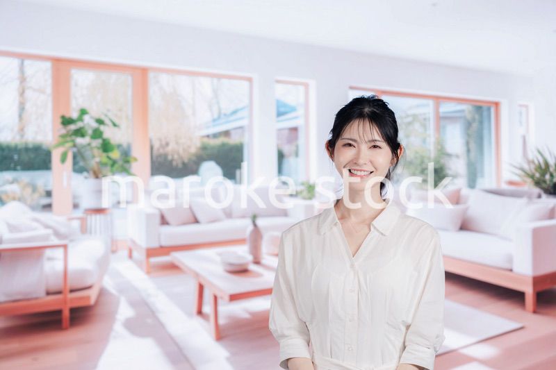 明るいリビングで過ごす若い女性