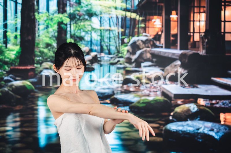 温泉でリラックスする若い女性