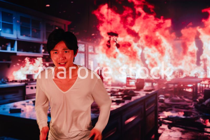 火災現場から走って逃げる若い男性